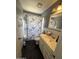 Cozy bathroom featuring a tiled shower, vanity, and floral shower curtain at 4823 W Palm Ln, Phoenix, AZ 85035