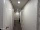 Bright hallway with recessed lighting, carpeted floors, and white walls at 4823 W Palm Ln, Phoenix, AZ 85035