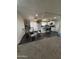 Open kitchen and dining area featuring white cabinetry, an island with seating, and hardwood floors at 4823 W Palm Ln, Phoenix, AZ 85035