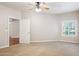 Light-filled carpeted bedroom with ceiling fan, window and doorway to hallway at 5450 E Deer Valley Dr # 1214, Phoenix, AZ 85054