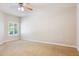 Light-filled carpeted bedroom with ceiling fan, window, and electrical outlets at 5450 E Deer Valley Dr # 1214, Phoenix, AZ 85054