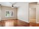 Bright bedroom featuring hardwood floors, a ceiling fan, and a shuttered window at 5450 E Deer Valley Dr # 1214, Phoenix, AZ 85054