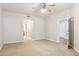 A large carpeted bedroom with a ceiling fan and doorway to the hallway at 5450 E Deer Valley Dr # 1214, Phoenix, AZ 85054