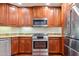 Well-lit kitchen features stainless steel appliances, granite countertops and wooden cabinetry at 5450 E Deer Valley Dr # 1214, Phoenix, AZ 85054