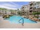 Resort-style pool with waterfalls, palm trees, and lounge chairs create an inviting and relaxing outdoor space at 5450 E Deer Valley Dr # 1214, Phoenix, AZ 85054