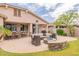Inviting outdoor living space with a fire pit, patio seating, and built-in grill for summer entertaining at 550 W Powell Way, Chandler, AZ 85248