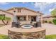 Stylish covered patio with a cozy fire pit and comfortable seating for outdoor gatherings at 550 W Powell Way, Chandler, AZ 85248