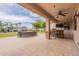 The backyard patio offers an outdoor stone bar, TV, fire pit, and a view of the pool, perfect for relaxation at 550 W Powell Way, Chandler, AZ 85248