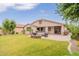 Lush backyard with a stone firepit, comfortable seating, and an outdoor grill, perfect for entertaining guests at 550 W Powell Way, Chandler, AZ 85248