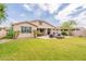 Spacious backyard with a covered patio, fire pit, and lush lawn perfect for outdoor living and entertaining at 550 W Powell Way, Chandler, AZ 85248