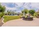 Extensive backyard featuring a pool with a rock waterfall, patio dining, and outdoor fire pit area at 550 W Powell Way, Chandler, AZ 85248