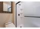 Bathroom features a modern shower with shelving and glass door, accompanied by an automatic toilet at 550 W Powell Way, Chandler, AZ 85248