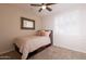 This bedroom is carpeted and has a ceiling fan and a window with plantation shutters for lots of light at 550 W Powell Way, Chandler, AZ 85248