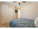 Bedroom with carpet, a ceiling fan, a closet with sliding doors, and a neatly made bed at 550 W Powell Way, Chandler, AZ 85248