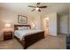 Comfortable bedroom with ensuite bathroom, features neutral walls and a ceiling fan at 550 W Powell Way, Chandler, AZ 85248