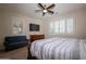 This bedroom features a TV, furniture, and large window with plantation shutters at 550 W Powell Way, Chandler, AZ 85248