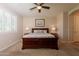 This neutral bedroom has carpeted floors and plantation shutters for adjustable light control and privacy at 550 W Powell Way, Chandler, AZ 85248