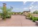 Landscaped common area with a clock tower, pergola, and manicured shrubs, enhancing the community's appeal at 550 W Powell Way, Chandler, AZ 85248