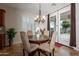 Dining room featuring a chandelier, table with chairs, and access to the backyard at 550 W Powell Way, Chandler, AZ 85248