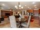 Dining room featuring a chandelier, table with chairs, and adjacent kitchen and living areas at 550 W Powell Way, Chandler, AZ 85248