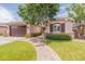 Charming single-Gathering home showcasing a beautiful front yard and a two-car garage, enhancing curb appeal at 550 W Powell Way, Chandler, AZ 85248