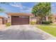 Home exterior with a two-car garage and well-maintained landscaping, offering both functionality and curb appeal at 550 W Powell Way, Chandler, AZ 85248