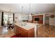 Open concept kitchen featuring stainless steel appliances, and adjacent dining and living areas at 550 W Powell Way, Chandler, AZ 85248