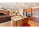 Open concept kitchen with stainless steel appliances, granite countertops, and adjacent living area at 550 W Powell Way, Chandler, AZ 85248