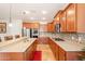 Spacious kitchen featuring granite countertops, stainless steel appliances, and wood cabinets at 550 W Powell Way, Chandler, AZ 85248