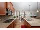 Open concept kitchen featuring stainless steel appliances, granite countertops, and adjacent dining area at 550 W Powell Way, Chandler, AZ 85248