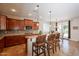 Gourmet kitchen featuring granite countertops, stainless steel appliances, and a breakfast bar at 550 W Powell Way, Chandler, AZ 85248