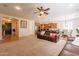 Open-concept living room with a view of the modern kitchen and a cozy dining area at 550 W Powell Way, Chandler, AZ 85248