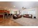 Spacious living area featuring plush carpeting, plantation shutters, and comfortable leather sofas at 550 W Powell Way, Chandler, AZ 85248