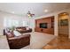 Bright living room with a custom built-in entertainment center and plantation shutters at 550 W Powell Way, Chandler, AZ 85248