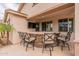 An outdoor stone bar with seating and a mounted TV, creating an ideal space for entertainment at 550 W Powell Way, Chandler, AZ 85248