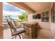 Covered patio features an outdoor stone bar with seating, perfect for enjoying outdoor living and entertainment at 550 W Powell Way, Chandler, AZ 85248