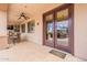 Relaxing covered patio with a ceiling fan, stone bar, and views of the pool through the French doors at 550 W Powell Way, Chandler, AZ 85248