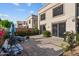 Backyard featuring a tiled patio, lush greenery, colorful flowers, and outdoor seating at 6002 N 5Th Pl, Phoenix, AZ 85012