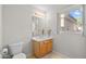 Bathroom featuring a single sink vanity, toilet, and a window at 6002 N 5Th Pl, Phoenix, AZ 85012