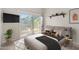 Modern bedroom with large window, a TV, and a sliding glass door to a balcony with outdoor scenery at 6002 N 5Th Pl, Phoenix, AZ 85012