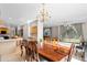 Open dining area with a dark wood table set, chandelier, and connecting views of kitchen and living area at 6002 N 5Th Pl, Phoenix, AZ 85012