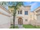Charming stucco home featuring a unique arched doorway and well-maintained landscaping, creating a welcoming curb appeal at 6002 N 5Th Pl, Phoenix, AZ 85012