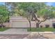 Charming home exterior featuring a two-car garage and beautiful mature trees in a well-maintained front yard at 6002 N 5Th Pl, Phoenix, AZ 85012