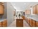 Bright kitchen features natural wood cabinetry, a spacious island, and a view to the back patio at 6002 N 5Th Pl, Phoenix, AZ 85012