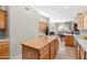 Kitchen featuring wooden cabinets, tiled floor, and an island with a butcher block top and view to the dining area at 6002 N 5Th Pl, Phoenix, AZ 85012