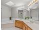 Spacious main bathroom with double vanity, soaking tub, and a large mirror with vanity lighting at 6002 N 5Th Pl, Phoenix, AZ 85012