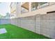 Townhouse backyard featuring a small grass area, brick wall and perimeter fence at 613 W Winchester Dr, Chandler, AZ 85286
