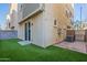 Townhouse backyard featuring a small grass area, sliding glass door and brick patio at 613 W Winchester Dr, Chandler, AZ 85286