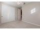Bright bedroom featuring a ceiling fan, plush carpet, and large closet with sliding doors at 613 W Winchester Dr, Chandler, AZ 85286
