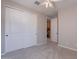 Neutral bedroom featuring a ceiling fan, plush carpet, and large closet with sliding doors at 613 W Winchester Dr, Chandler, AZ 85286